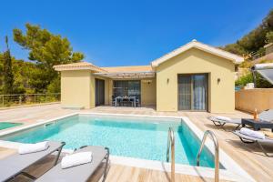 a villa with a swimming pool and a house at Villa Gerasmia in Trapezaki