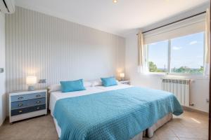 a bedroom with two beds and a window at Villa Fina in Colònia De Sant Jordi +26 photos