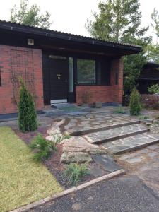 a house with a stone walkway in front of it at Kotimaailma Apartments - Cozy and spacious house in Naantali +9 photos