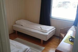a small room with a bed and a window at Kotimaailma Apartments - Cozy and spacious house in Naantali