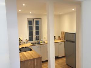 a kitchen with white cabinets and a stainless steel refrigerator at Im Herzen der Altstadt in Heidelberg