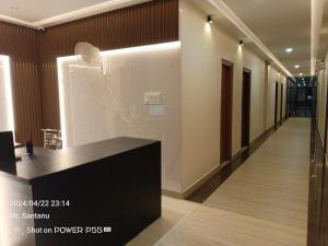 a hallway with a black counter in a building at Sree Durga Hotel Ramsons International in Mysore
