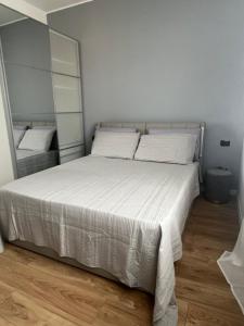 a bedroom with a large bed with white sheets at Monolocale Ovidio in Milan