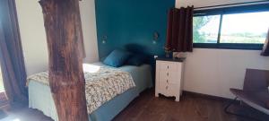 a small bedroom with a bed and a window at La chouette in La Malonie