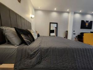 a bedroom with a large bed with pillows on it at Suite Tlaquepaque centro in Guadalajara +65 photos