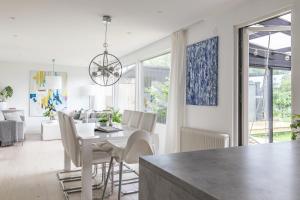 Private villa in central Östersund في أوسترسوند: غرفة طعام وغرفة معيشة مع طاولة وكراسي +14 صورة