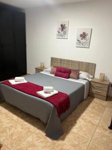 a bedroom with a large bed with two towels on it at Garza Attic House in Ojos de Garza