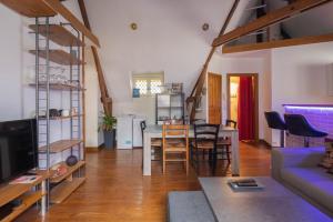 a living room with a couch and a dining room at Appartement spacieux au cœur d'Angers étage 3 - 6 personnes in Angers