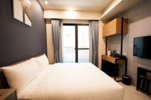 Postel nebo postele na pokoji v ubytování Chi Fong Ocean City Hotel