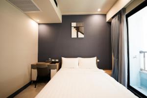 Postel nebo postele na pokoji v ubytování Chi Fong Ocean City Hotel