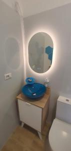 a bathroom with a blue sink and a mirror at Il Porto Segreto in Siracusa