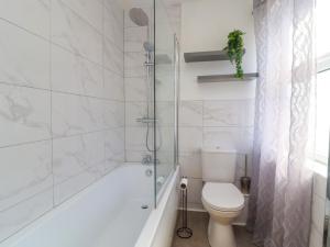 a white bathroom with a toilet and a shower at 49 Waddington Road in Clitheroe +17 photos