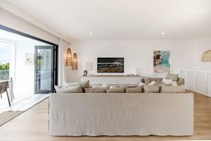 a living room with a couch and a table at 'Sunny', Luxury in Paradise, Sunrise Beach, Noosa in Sunrise Beach