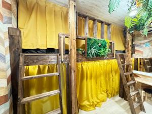 a room with a bed with yellow curtains at New open Hotel Jungle fun fun J4 USJ 8minutes nishikujyo 3minutes in Osaka