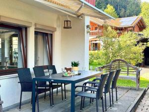 a blue table and chairs on a patio at Alpines Wohlfühl-Apartment OPlus in Oberstaufen
