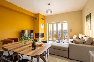 a living room with a table and a couch at Martinia Pool Getaways - Majestic Panoramic Views in Áno Ámfia +43 photos