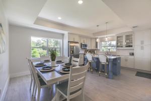 a kitchen and dining room with a table and chairs at Beach Please in Sanibel