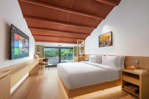 a bedroom with a large white bed and a tv at Jun hade on hillside in Hangzhou +70 photos