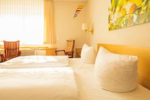 Postel nebo postele na pokoji v ubytování Hotel Luise