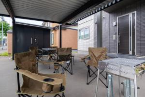 a patio with a table and chairs and a table and chairsktop at The Exeparel in Kushiro