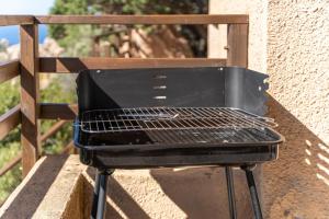a grill sitting on the side of a wall at Villetta Panoramica Costa Paradiso in Costa Paradiso