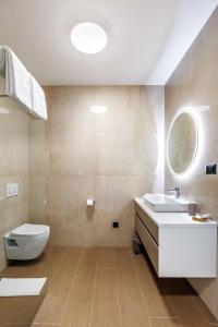 a bathroom with a white sink and a toilet at Stella Maris in Podstrana