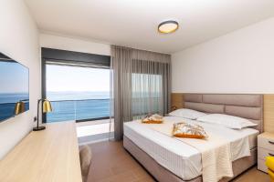 a bedroom with a bed and a large window at Stella Maris in Podstrana +23 photos