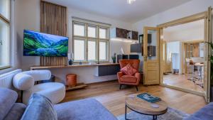 a living room with a couch and a table at LAGOM - Hot Tub Hideout in Braşov