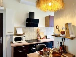 a kitchen with a table with wine glasses on it at Suite Marrakech - Rennes centre in Rennes