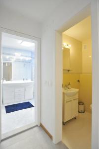 a bathroom with a tub and a sink at Strict city apartments in Ljubljana