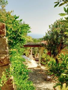 a garden with a bridge and some bushes at Villa d'Artisti in Sanremo