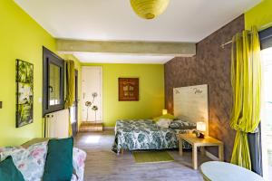 a bedroom with a bed and a couch and a table at La Trappe in Sarlat-la-Canéda +25 photos