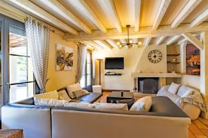 a living room with a couch and a fireplace at La Trappe in Sarlat-la-Canéda
