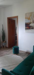 a living room with a green couch and a cactus at Ca Du Stea in Lavagna