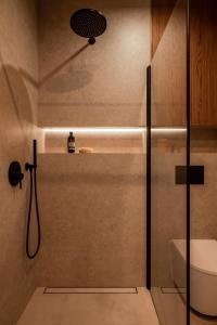 a bathroom with a shower with a sink and a toilet at NOOK Cabins - Mountain View in Zakopane +22 photos