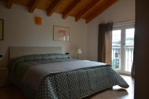 a bedroom with a bed and a large window at Monte Goj Apartments in Como