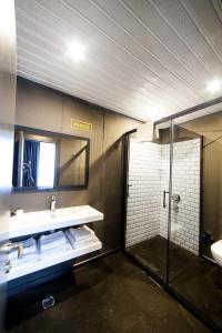 a bathroom with a sink and a shower and a mirror at Inn 65 Budget in Ankara