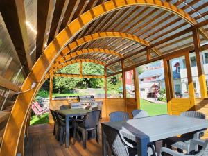 an outdoor dining area with tables and chairs at Casa Turta Dulce in Buşteni