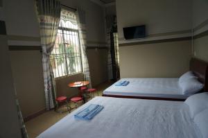 Giường trong phòng chung tại Thanh Lich Guesthouse