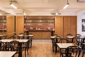 an empty restaurant with tables and a counter at New Hotel Opéra in Paris