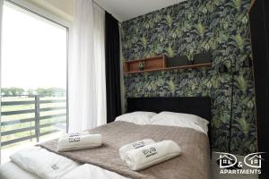 a bedroom with a bed with two pillows on it at Apartamenty Morze u Sary in Dziwnówek