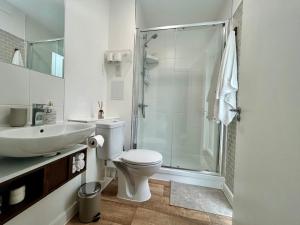 a bathroom with a toilet and a sink and a shower at My Apartment Brixton - Modern Double Room with En-suite in London