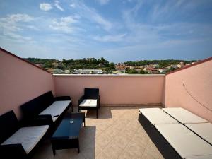 a balcony with benches and a view of a city at Apartments Maričić Rab Island in Rab