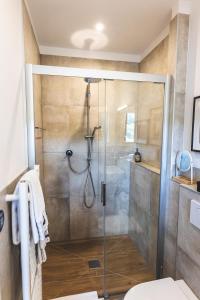 a shower with a glass door in a bathroom at Boutique Hotel LANDHAUSZEIT in Bad Münstereifel +141 photos