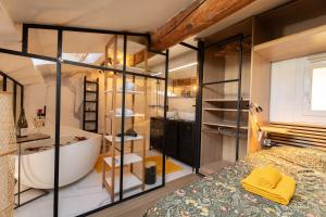 a bathroom with a tub and a sink and a bed at Loft COSY et luxueux, HYPER-CENTRE in Aix-en-Provence