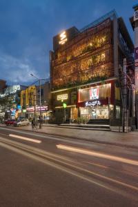 a building on a city street at night at Fressotel, Kanakapura Road in Bengaluru