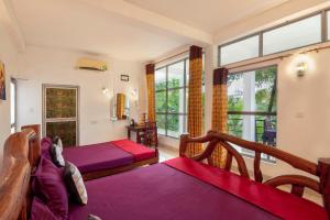 Postel nebo postele na pokoji v ubytování Ayurvedic Lanka Wellness Hotel