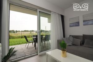 a living room with a couch and a table at Apartamenty Morze u Sary in Dziwnówek