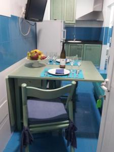 a small table with a bottle of wine and glasses at Estúdio Berlenga in Nazaré