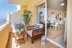 a balcony with a dining room and a living room at Blue Garden - cozy apartment with Atlantic views in Puerto de Santiago +36 photos